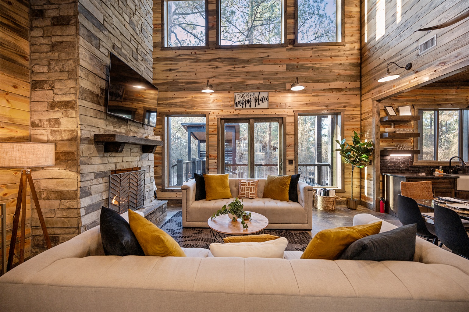 Large windows fill the space with natural light and peaceful forest views.