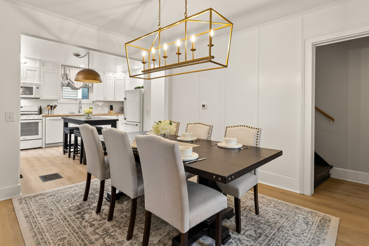 Dining table beneath a rectangular light fixture