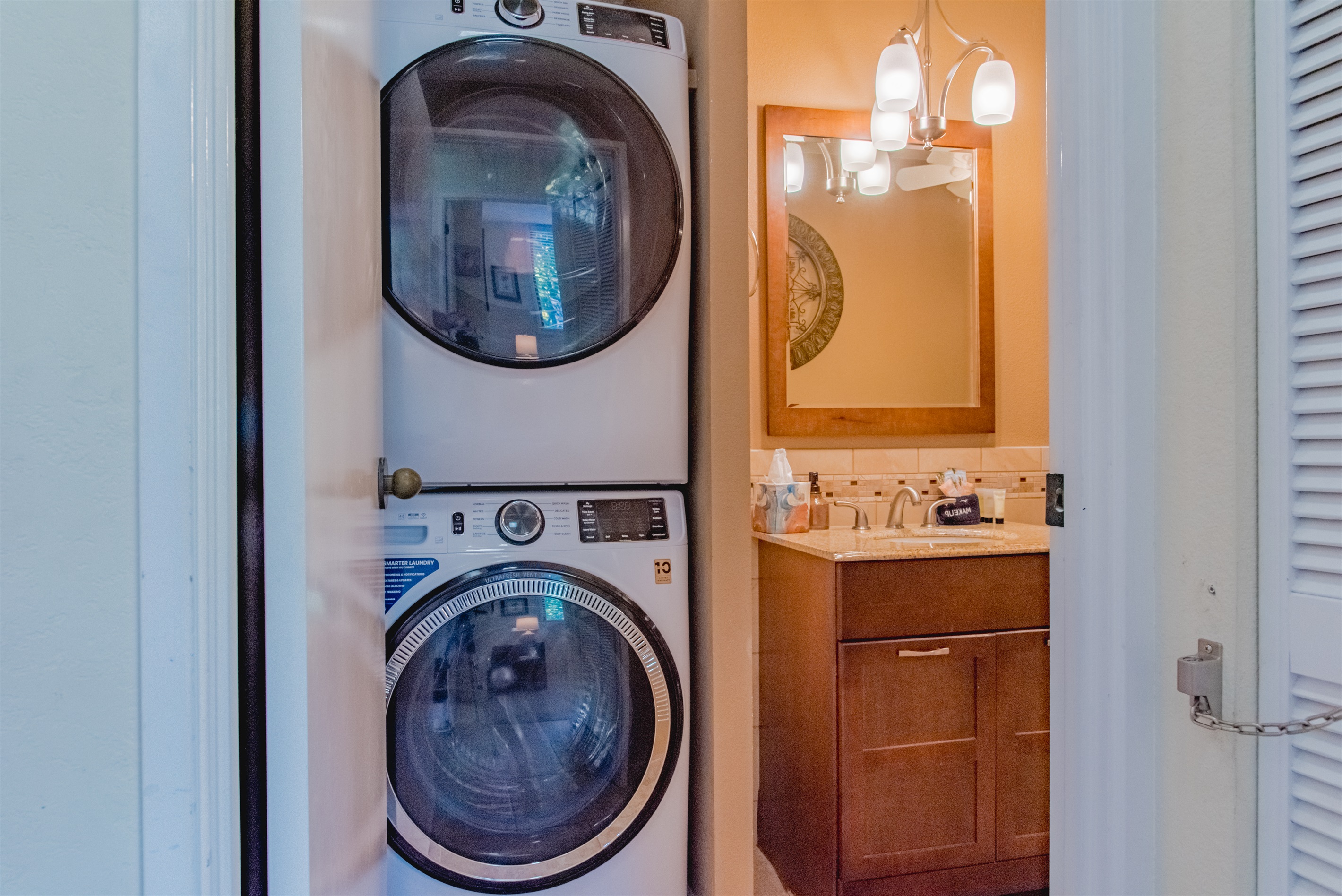 Guest bathroom localed off hallway with new in-house GE washer and dryer combo.