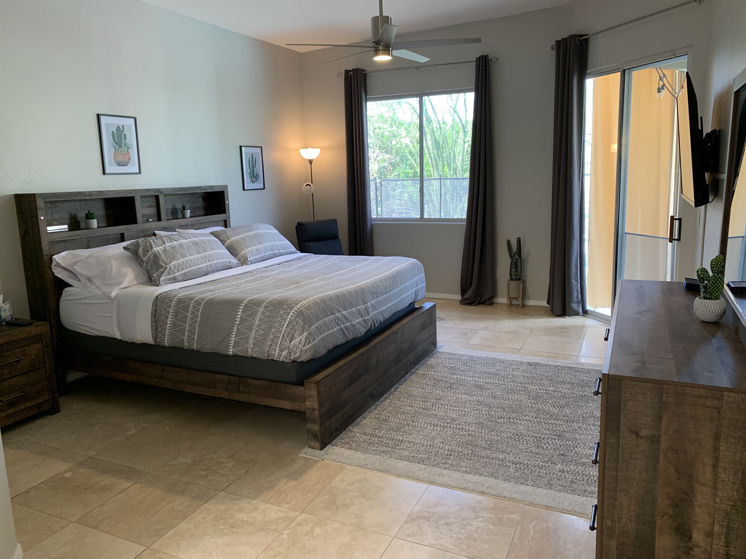 You'll sleep great in the spacious primary bedroom. King size bed, 2 nightstands, dresser and a recliner. Walk right out the sliding doors to the backyard and pool.