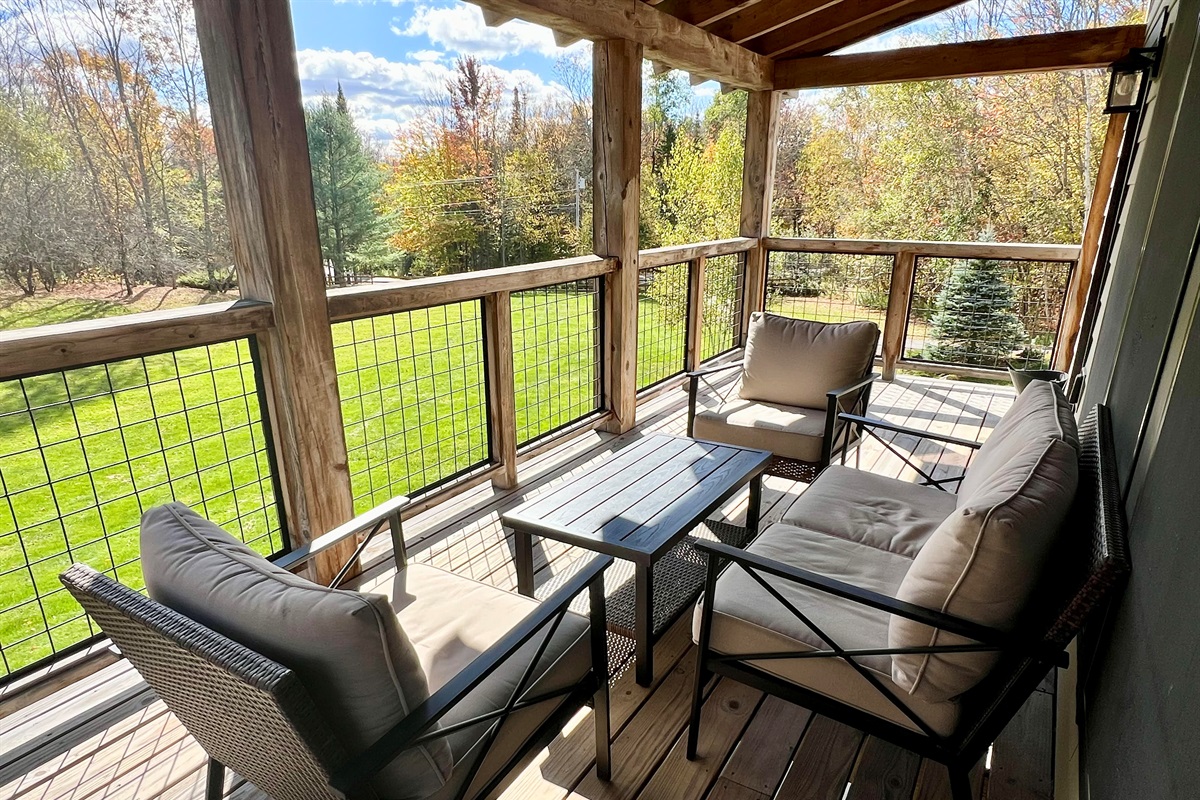 Large covered deck off living room is the perfect place to relax on a Summer or fall da