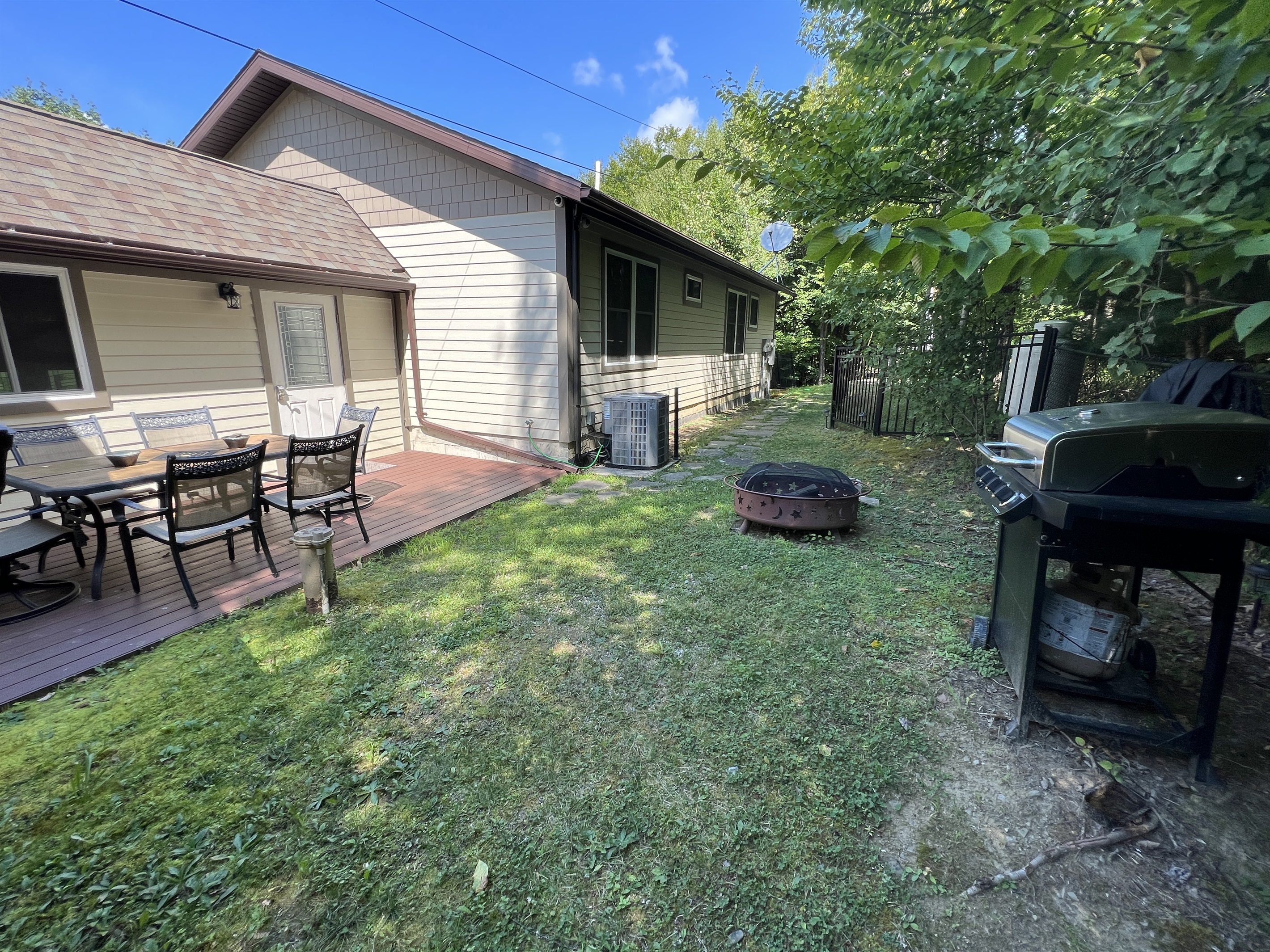 Fire pit and gas grill for unit 2, note pathway to private driveway and parking.