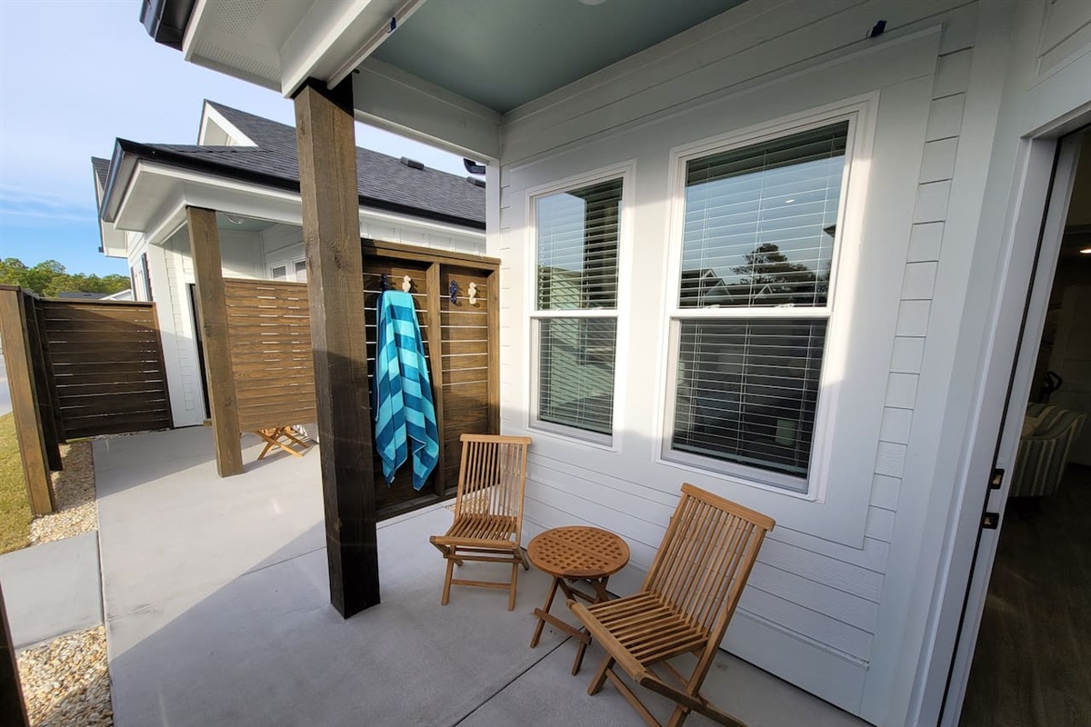 Covered patio has seahorse hooks for air drying your beach towels.  