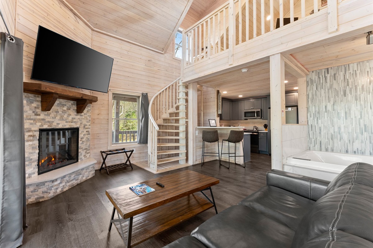 Open-Concept Space with Spiral Staircase Leading Up to the Loft