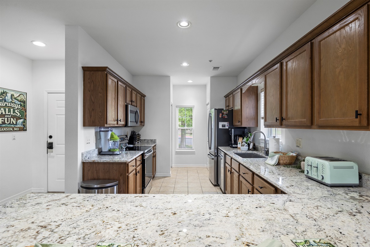 The kitchen and eat-in bar are so spacious everyone can gather for cooking, eating, laughing and telling stories