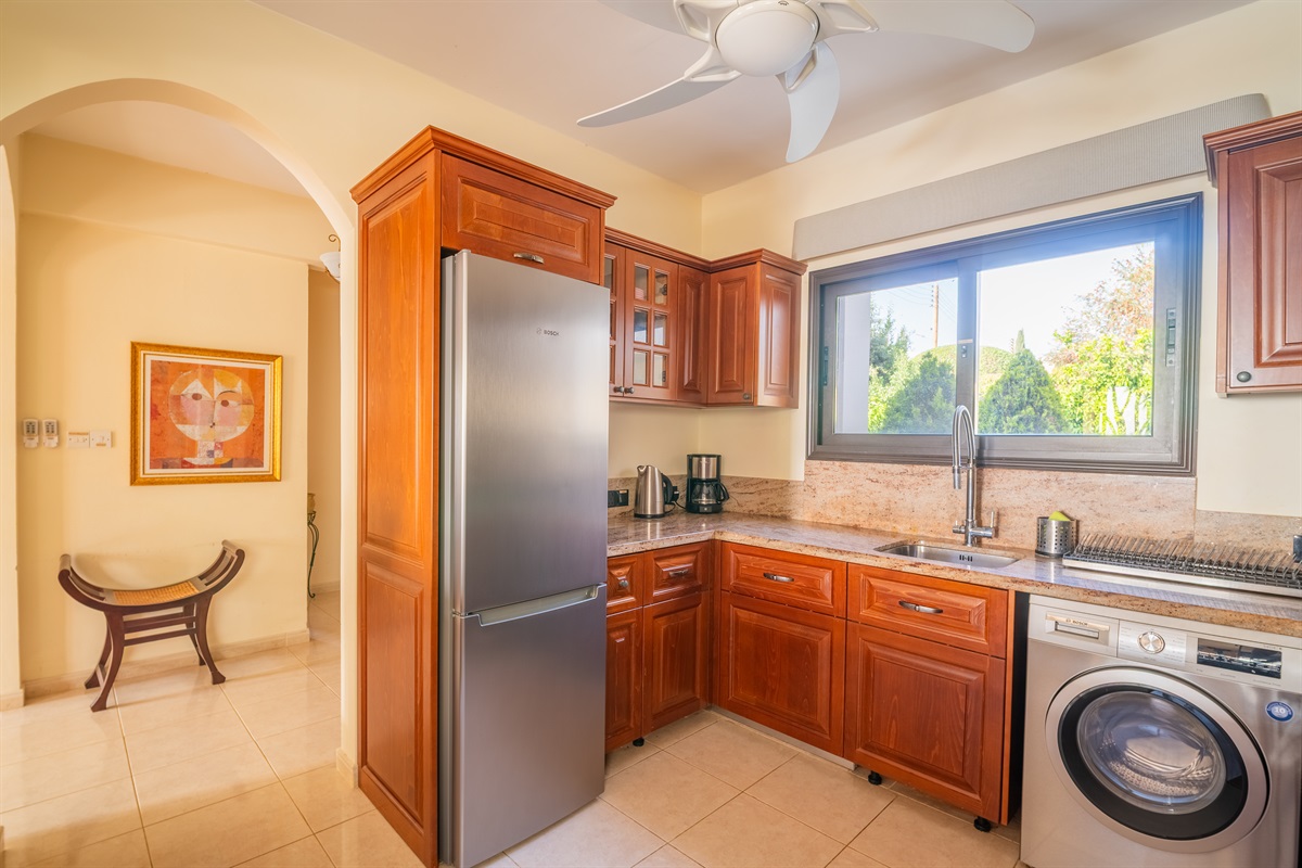 Enjoy cooking in a newly renovated kitchen featuring granite countertops and Bosch appliances, perfect for preparing meals with ease. The open layout connects seamlessly to the living area through a granite bar, making it easy to socialize while you cook.