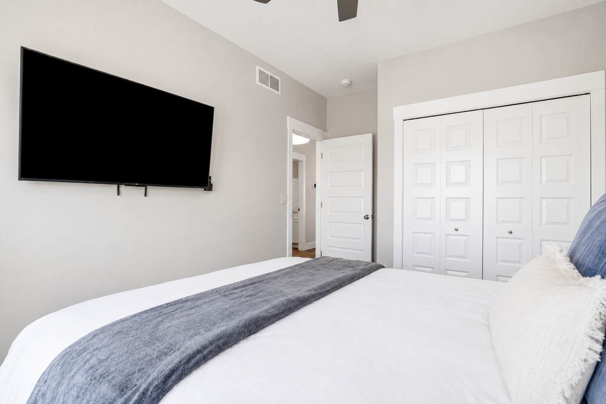 Whether you're winding down with your favorite show on the 55" Roku TV or unpacking with the luggage rack and closet space, this bedroom is designed to feel like home.