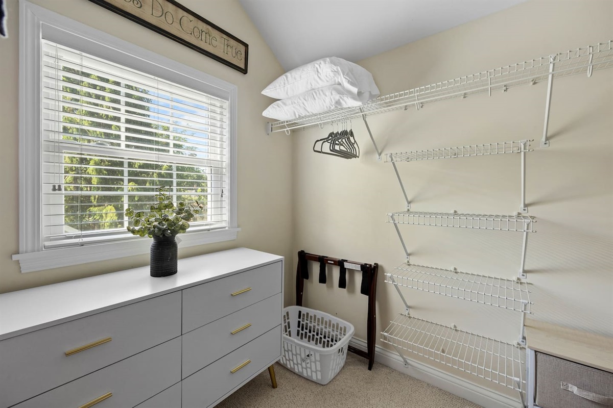 Spacious walk-in closet filled with natural light. Plenty of shelves and drawers to help you keep your things organized. Luggage racks, laundry basket, hangers, and extra pillows also available for your use.