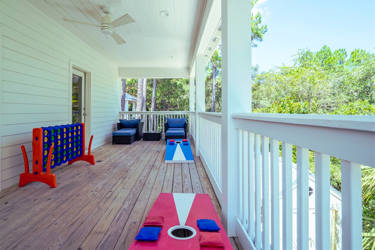 Spacious deck with seating areas, cornhole, and ring toss - perfect for outdoor fun and relaxing evenings