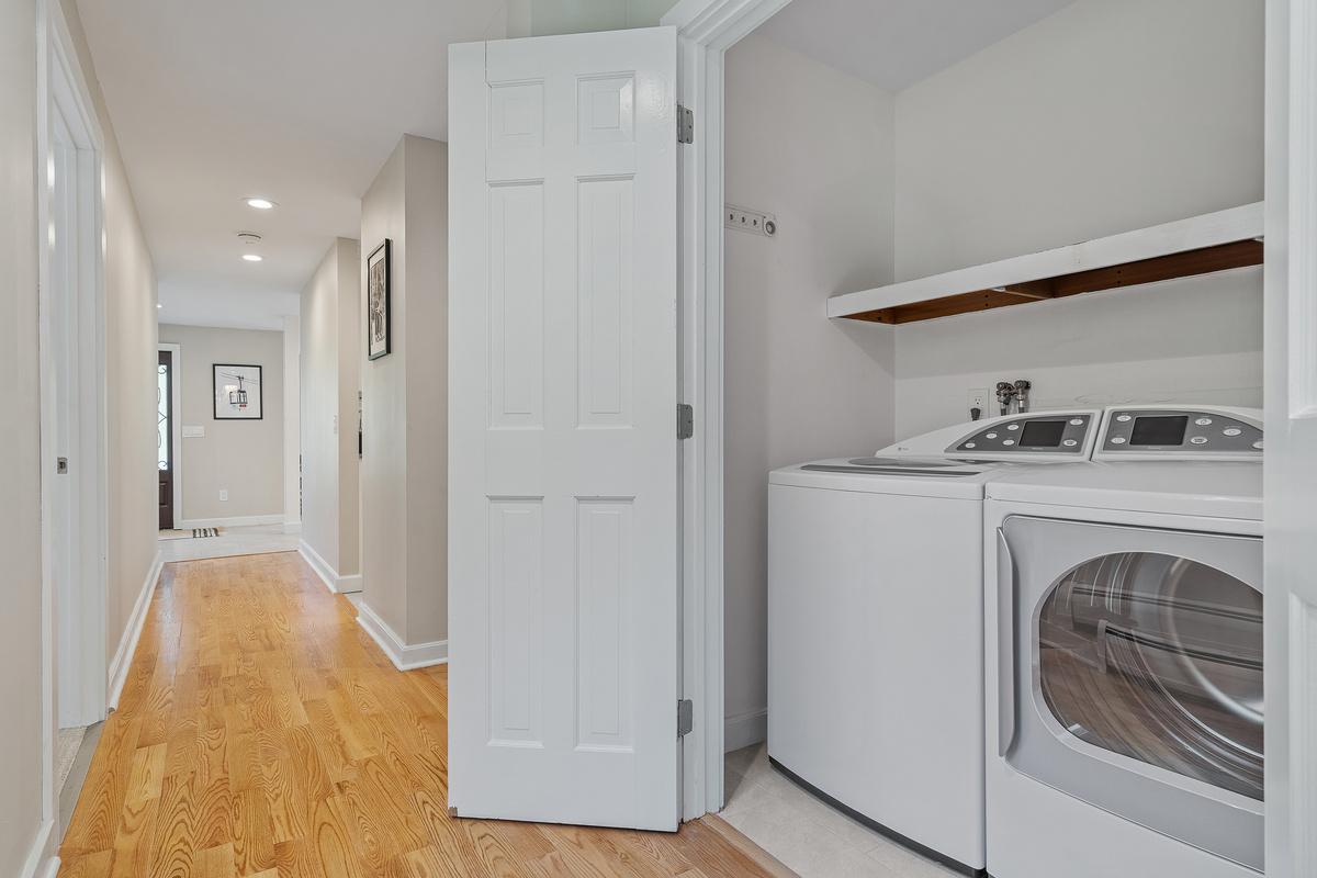 Hallway laundry center with full-size washer and dryer for longer ski stays
