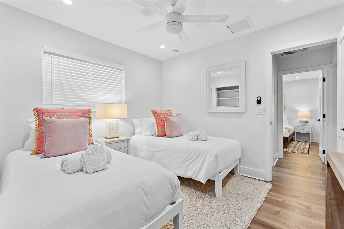Perfect for friends or family, this cozy twin bedroom offers stylish comfort, soft textures, and plenty of natural light.