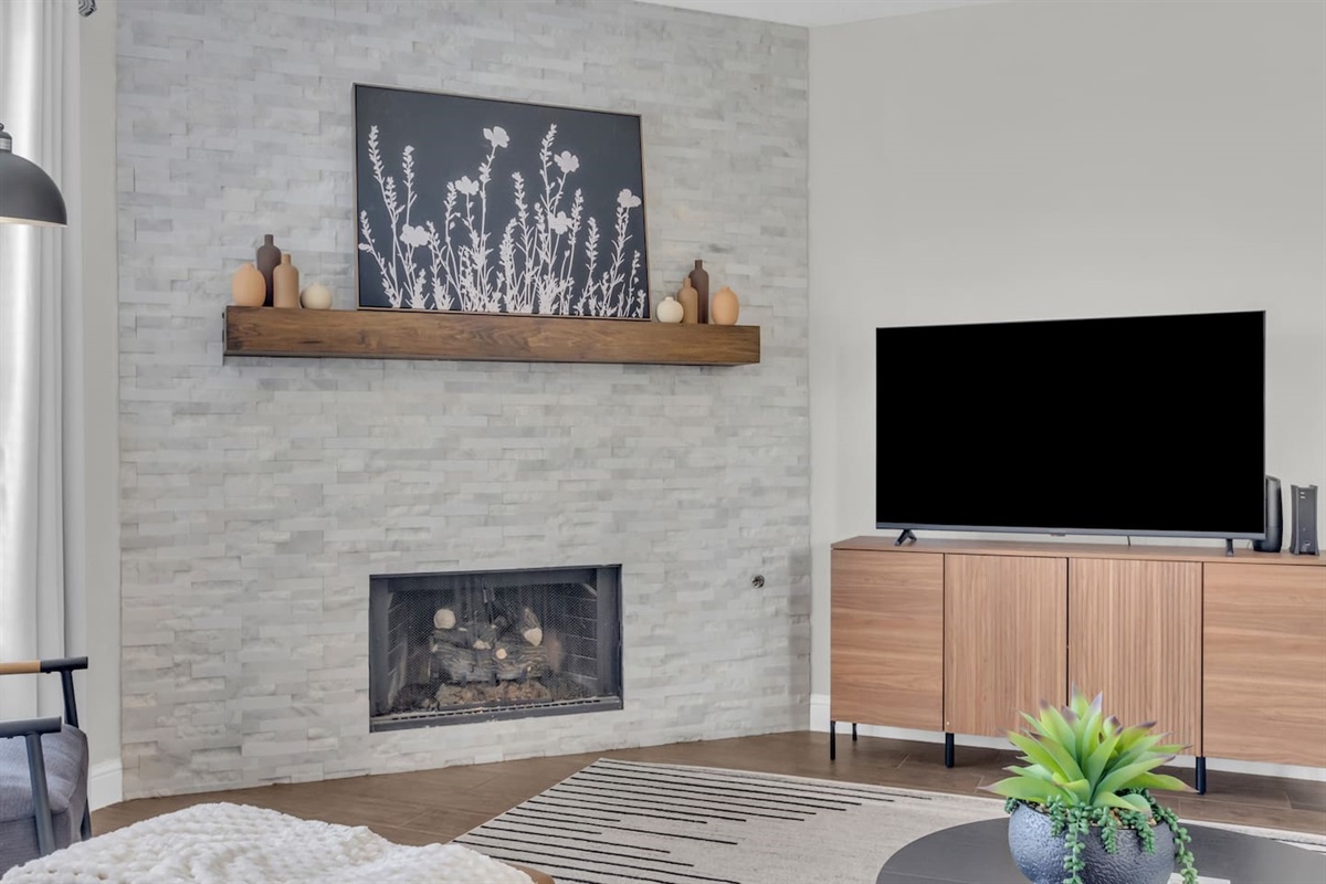 Comfortable living area equipped with a Smart TV, and fire place perfect for getting cozy and streaming your favorite shows and movies.