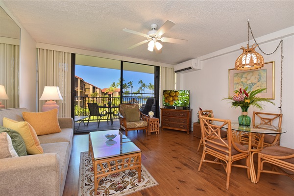 Living room with flat screen TV and AC unit above