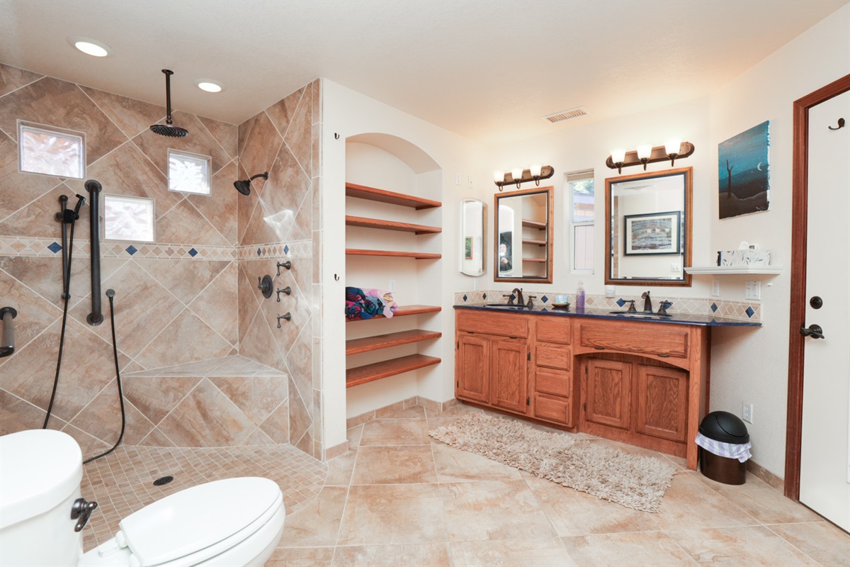 Spacious, roll-in shower with modern fixtures and natural light—designed for ease, comfort, and peace of mind.