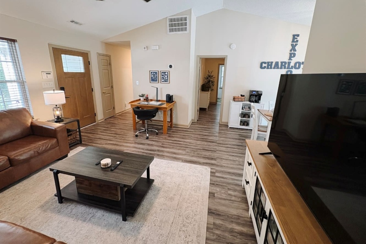 Living Room with 65" Smart TV, dedicated workspace, cards, board games and cozy seating!