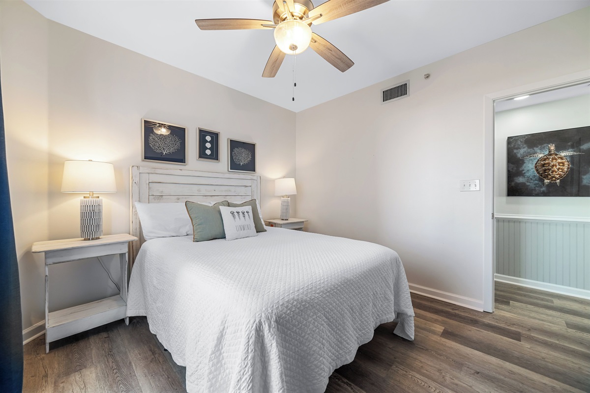 Bedroom 2 with king bed, ceiling fan and direct balcony access