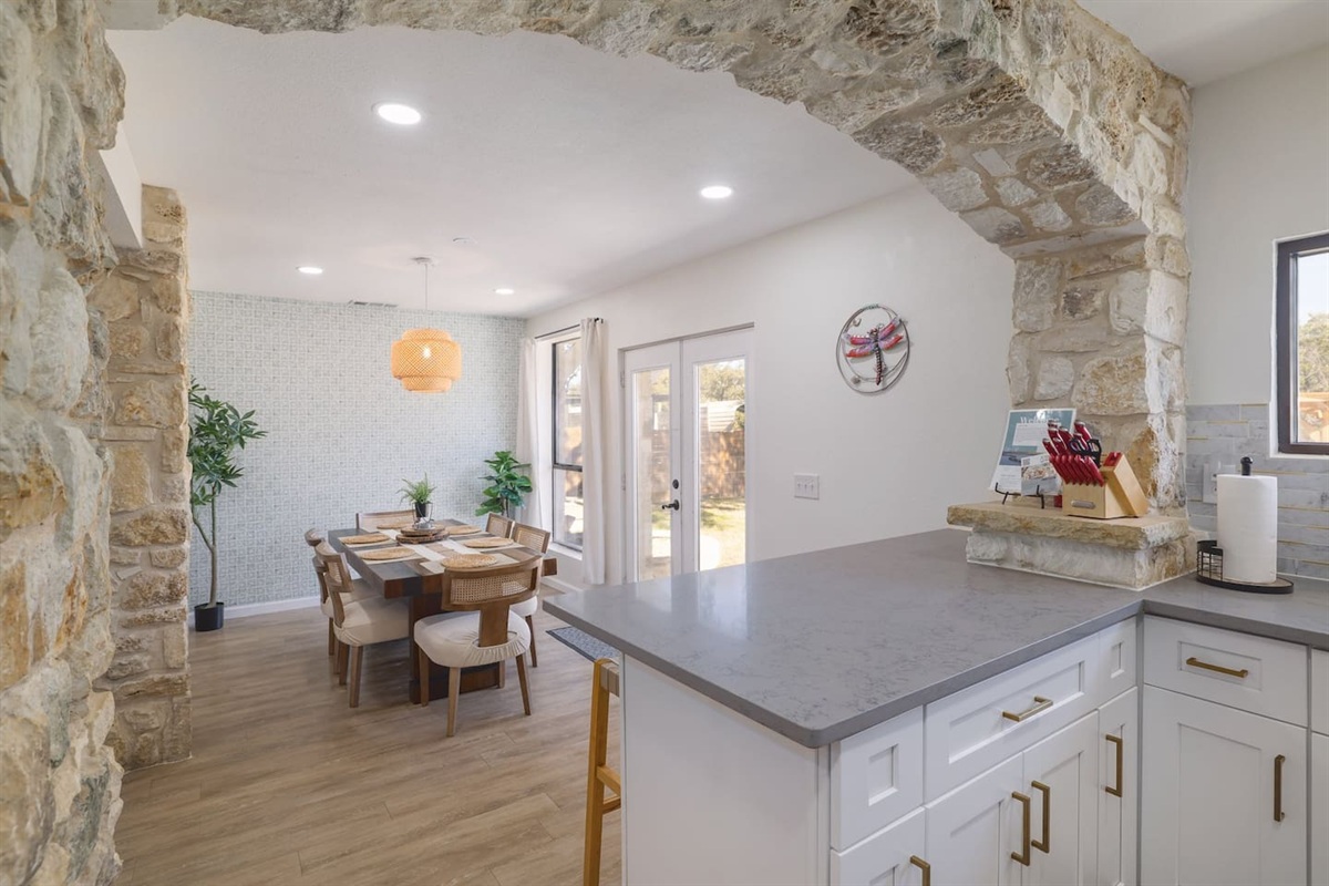 Gather around for slow breakfasts, shared dinners, and easy conversation in a bright dining space framed by beautiful stone archways. Warm textures and natural light make every meal feel a little more special.