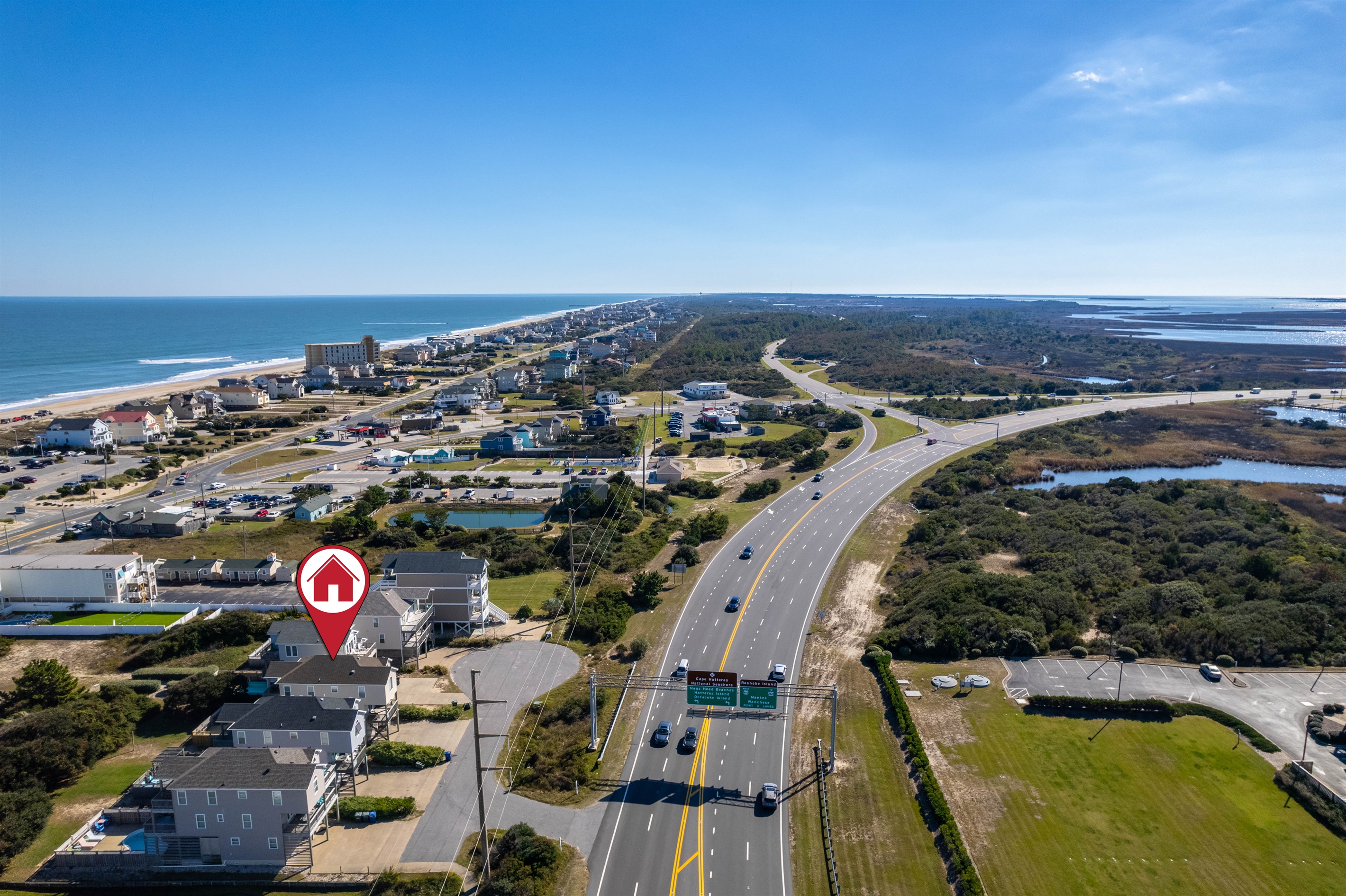 Aerial view highlighting the home’s prime location just a short walk from the beach, shops, and the iconic Jennette’s Pier.