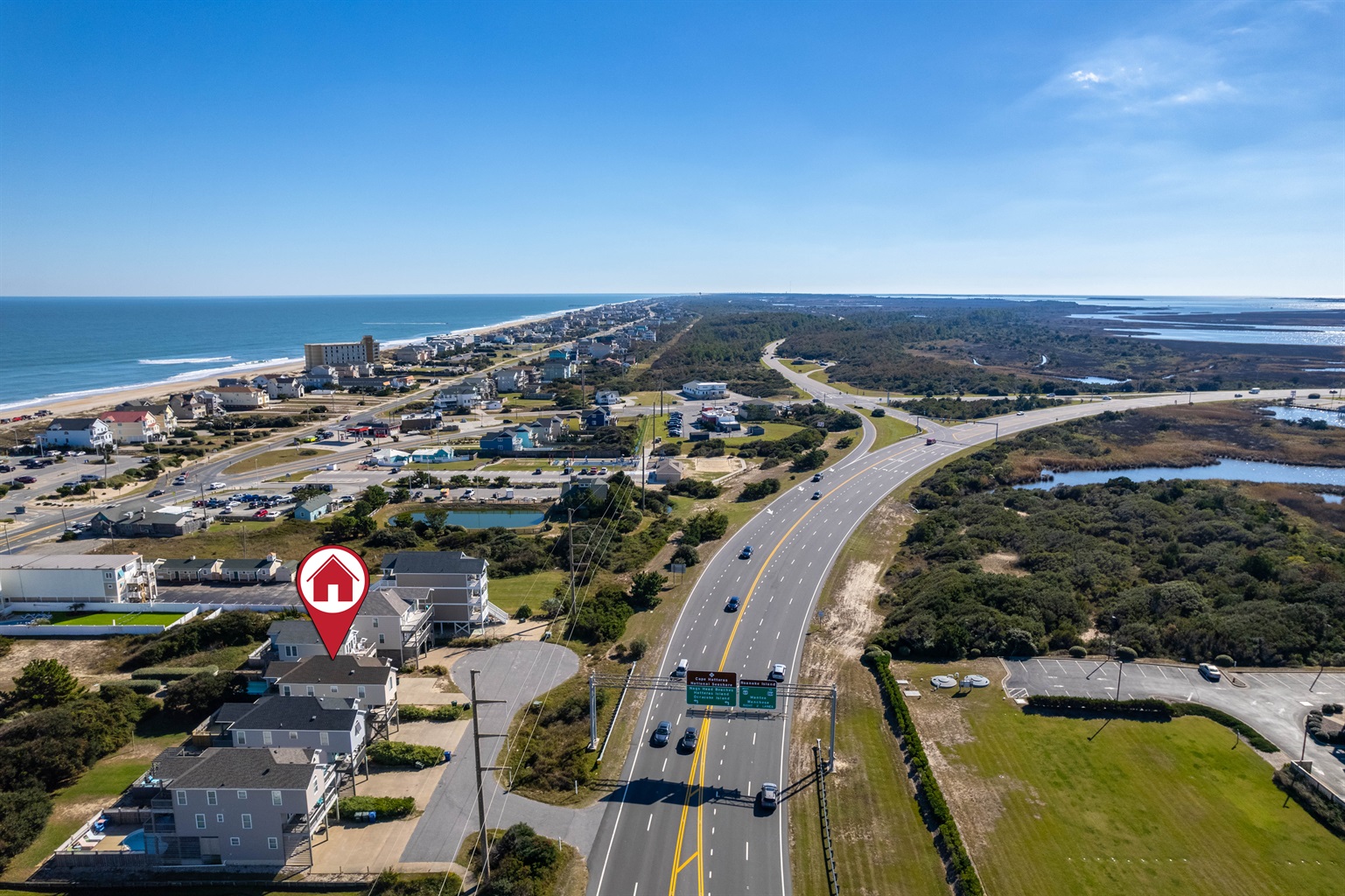 Aerial view highlighting the home’s prime location just a short walk from the beach, shops, and the iconic Jennette’s Pier.