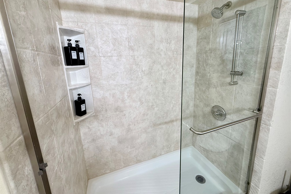 Full bath attached to primary bedroom, with beautiful glass shower.