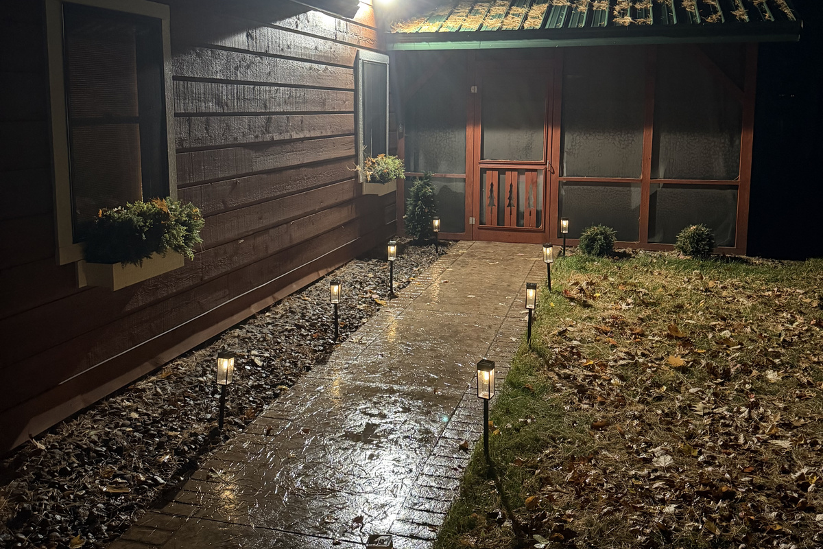 The front walk to the screen porch at night.
