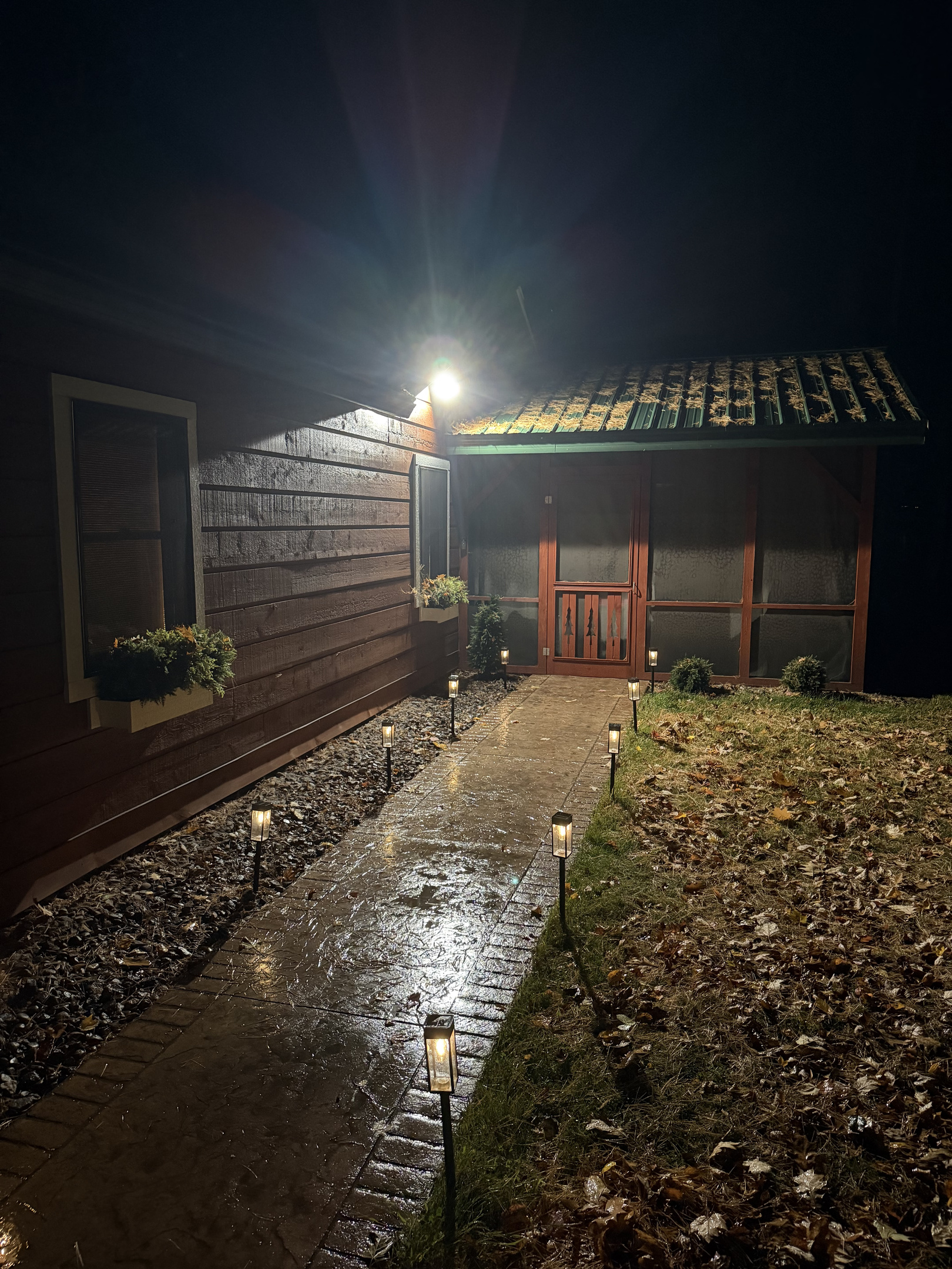 The front walk to the screen porch at night.