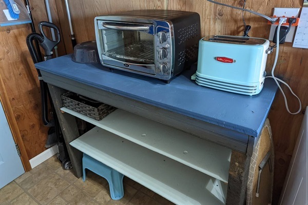 Storage space in hall, toaster, toaster oven & microwave.