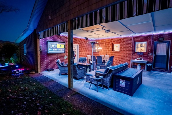 Enjoy a covered outdoor lounge with comfy seating, LED lighting, a fire table, patio heater, and a 65” outdoor TV. Perfect for relaxing, watching games, or spending time together year-round.