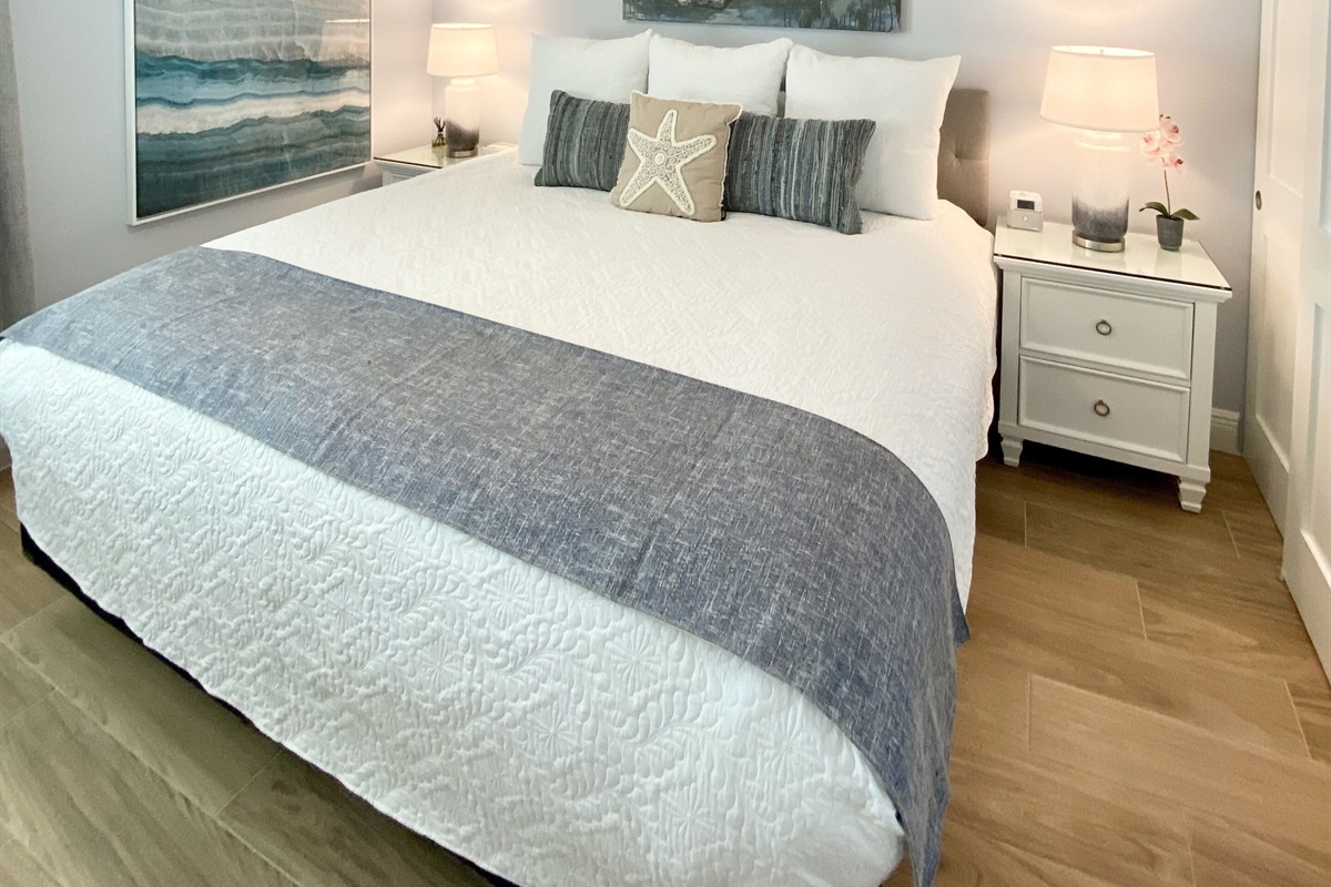 King Bed & a Large flat screen TV on wall. Custom built-in closet w/ drawers