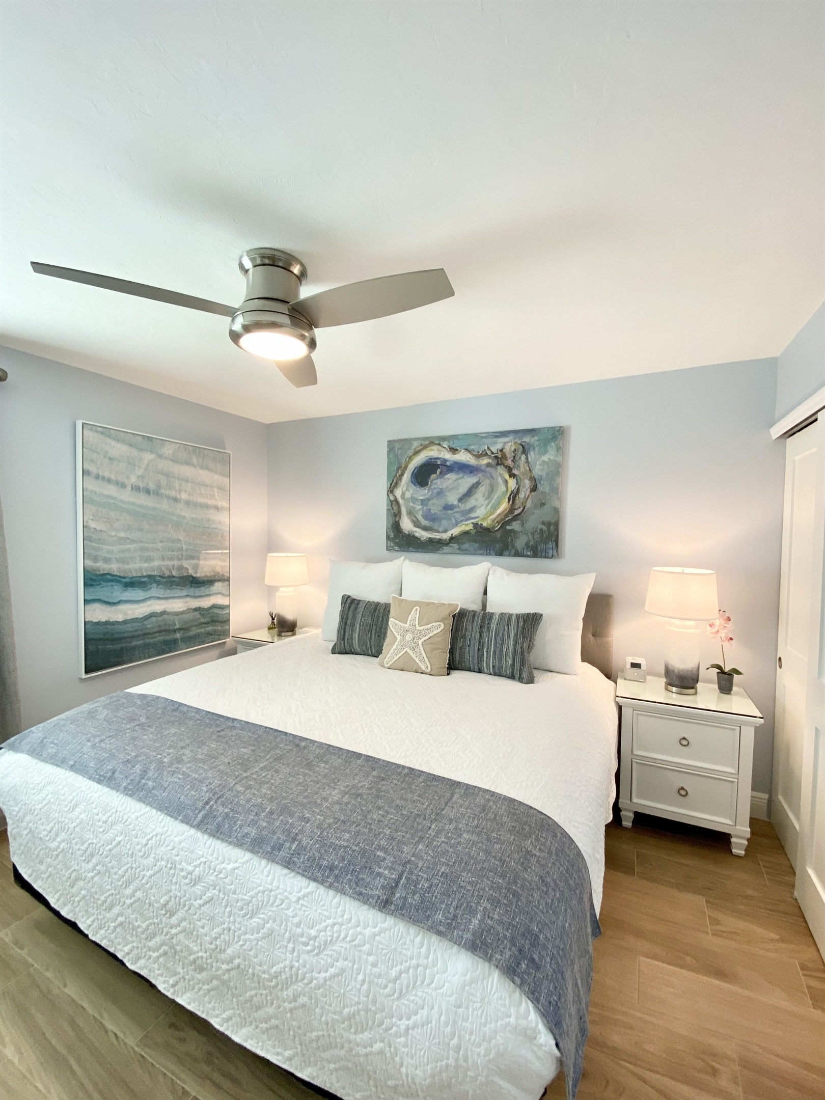 King Bed & a Large flat screen TV on wall. Custom built-in closet w/ drawers