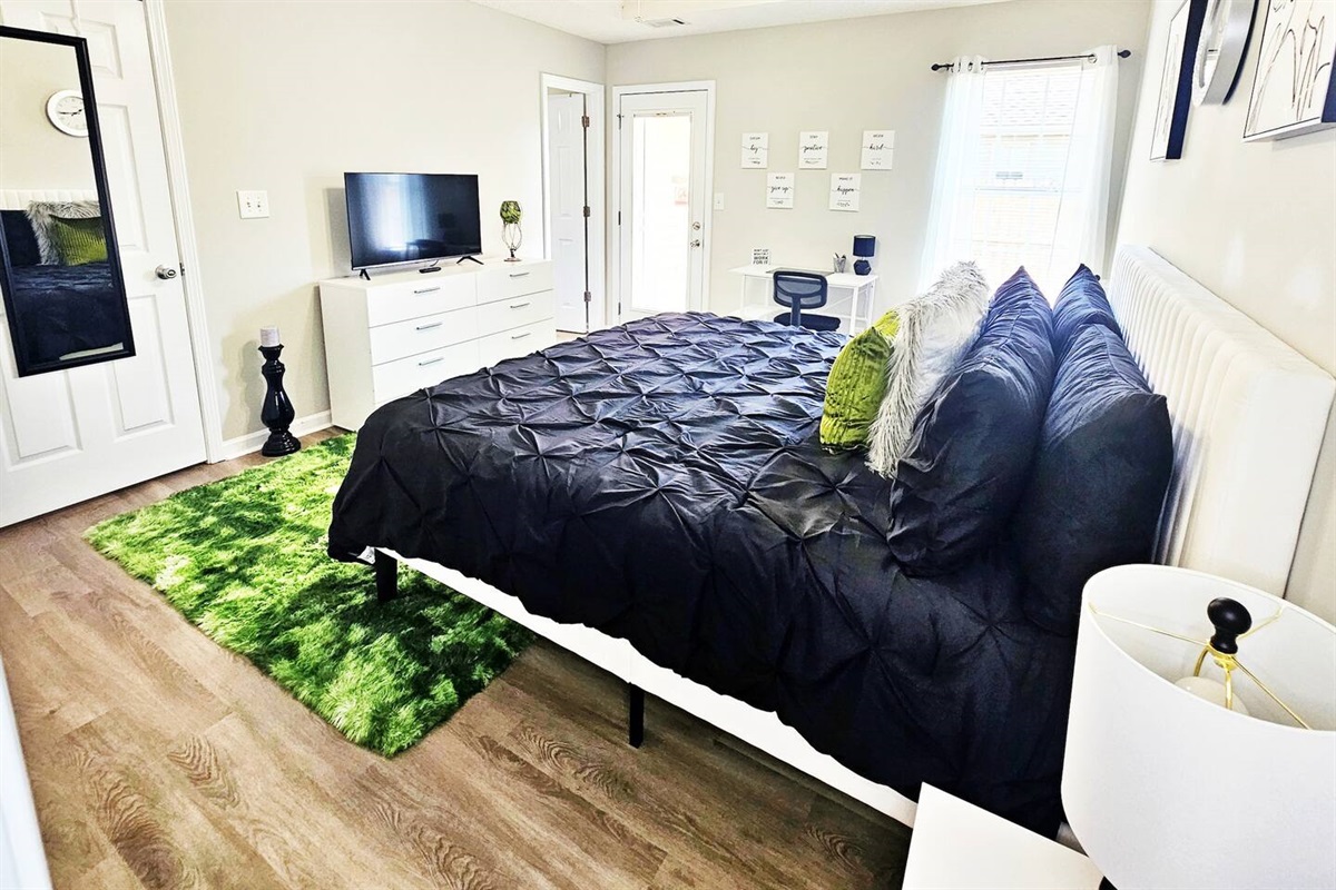 Every room has a full-length mirror and flat-screen smart TV.
Step out the door to the back patio & fenced-in backyard. 