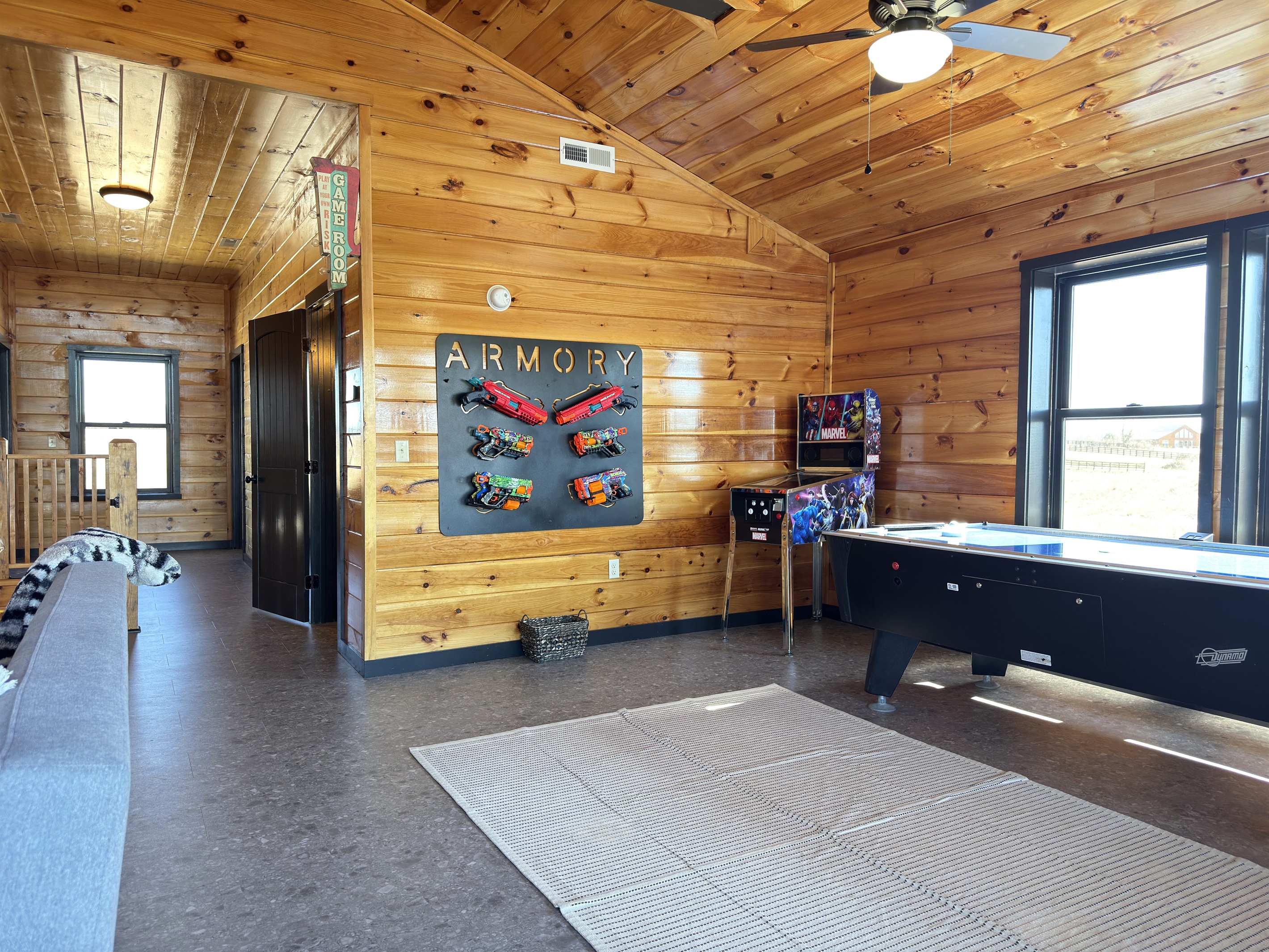 Upstairs game room with nerf blaster, air hockey, & retro arcades.