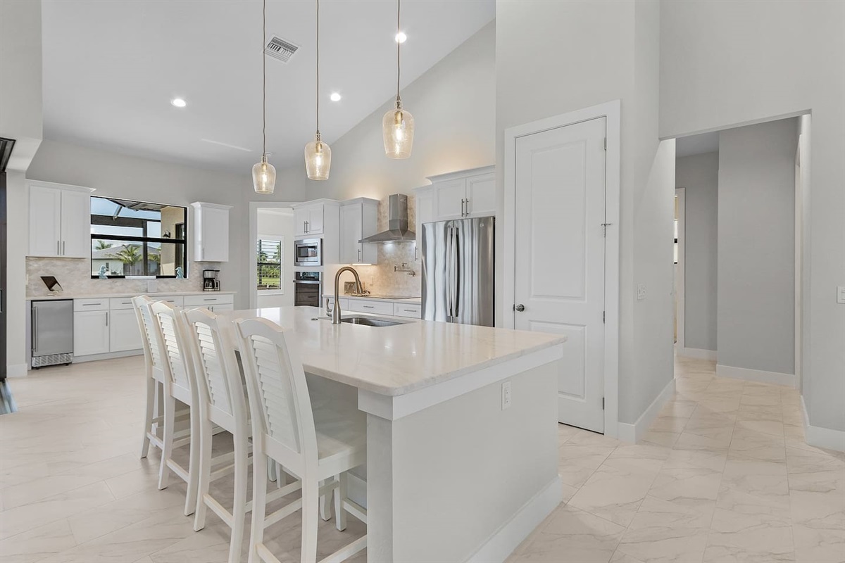 Indulge in a spacious gourmet kitchen featuring an elegant island that seats 4—perfect for entertaining guests or crafting exquisite meals in style!