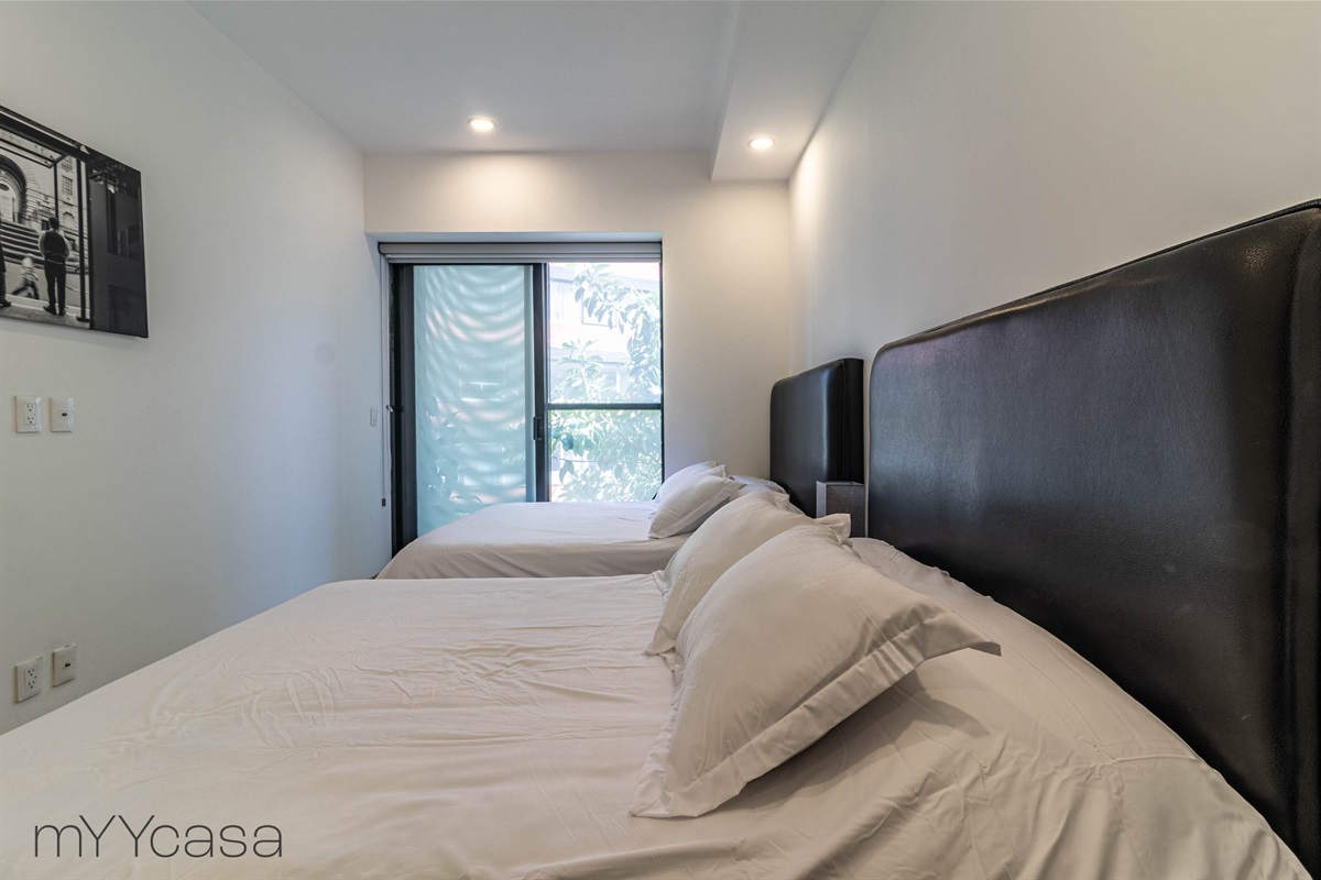 Third bedroom with two queen beds, providing luxurious comfort and ample sleeping space