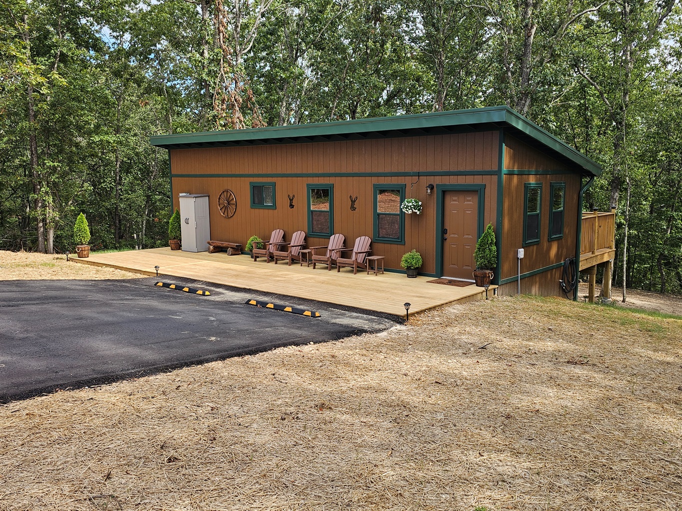 Welcome to your woodland getaway! Pull right up, grab a seat on the porch, and let the forest backdrop set the tone for a relaxing stay.