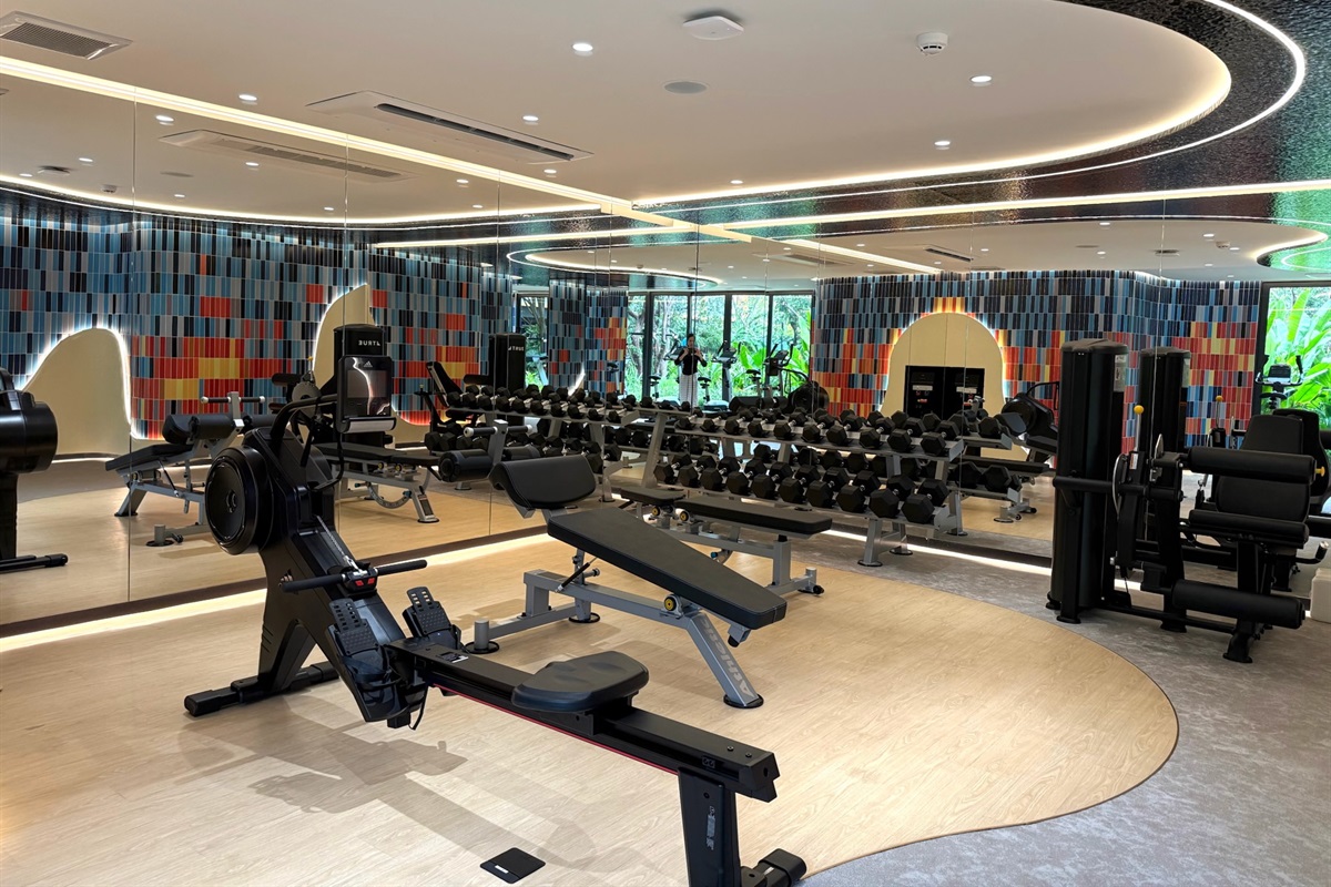 Enhance your workout—whether strength training or cardio—with an underwater-themed space featuring coral murals and garden views.