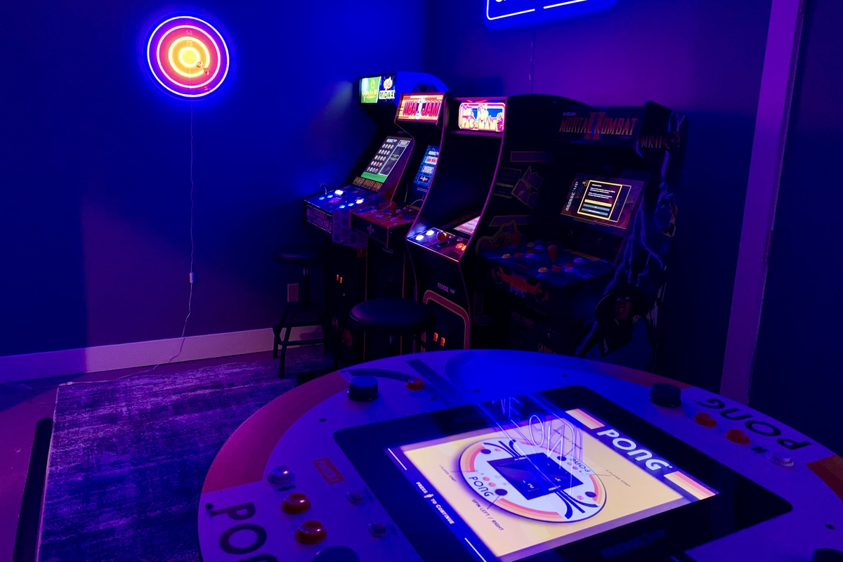 The dedicated arcade room is packed with nostalgic favorites—from Golden Tee and NBA Jam to Mortal Kombat, Ms. Pac-Man, and a one-of-a-kind 4-player Pong table.