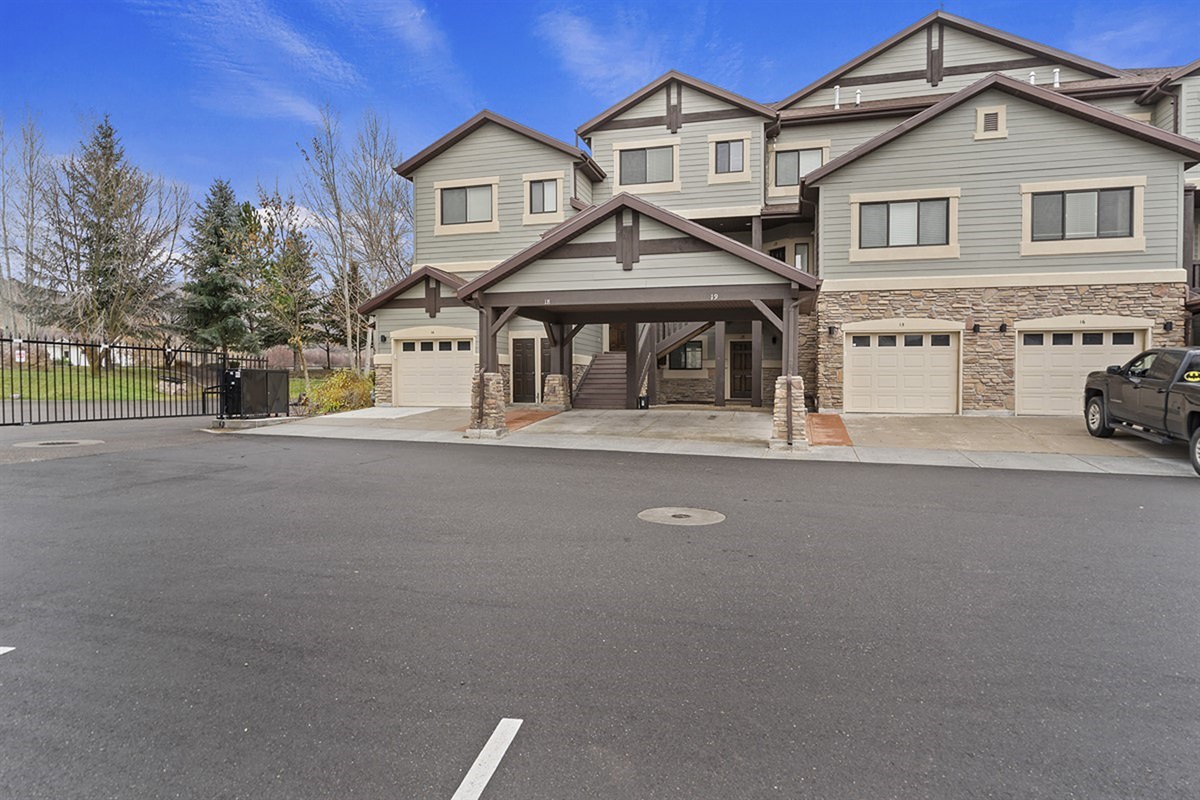 A welcoming front exterior showcasing refined mountain architecture, nestled in a peaceful neighborhood with easy access to all Lakeside Village amenities.