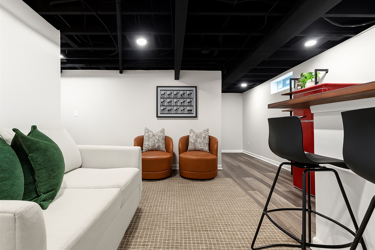 Relax downstairs with comfy seating, bar access, and a welcoming space perfect for movie nights or casual hangouts.