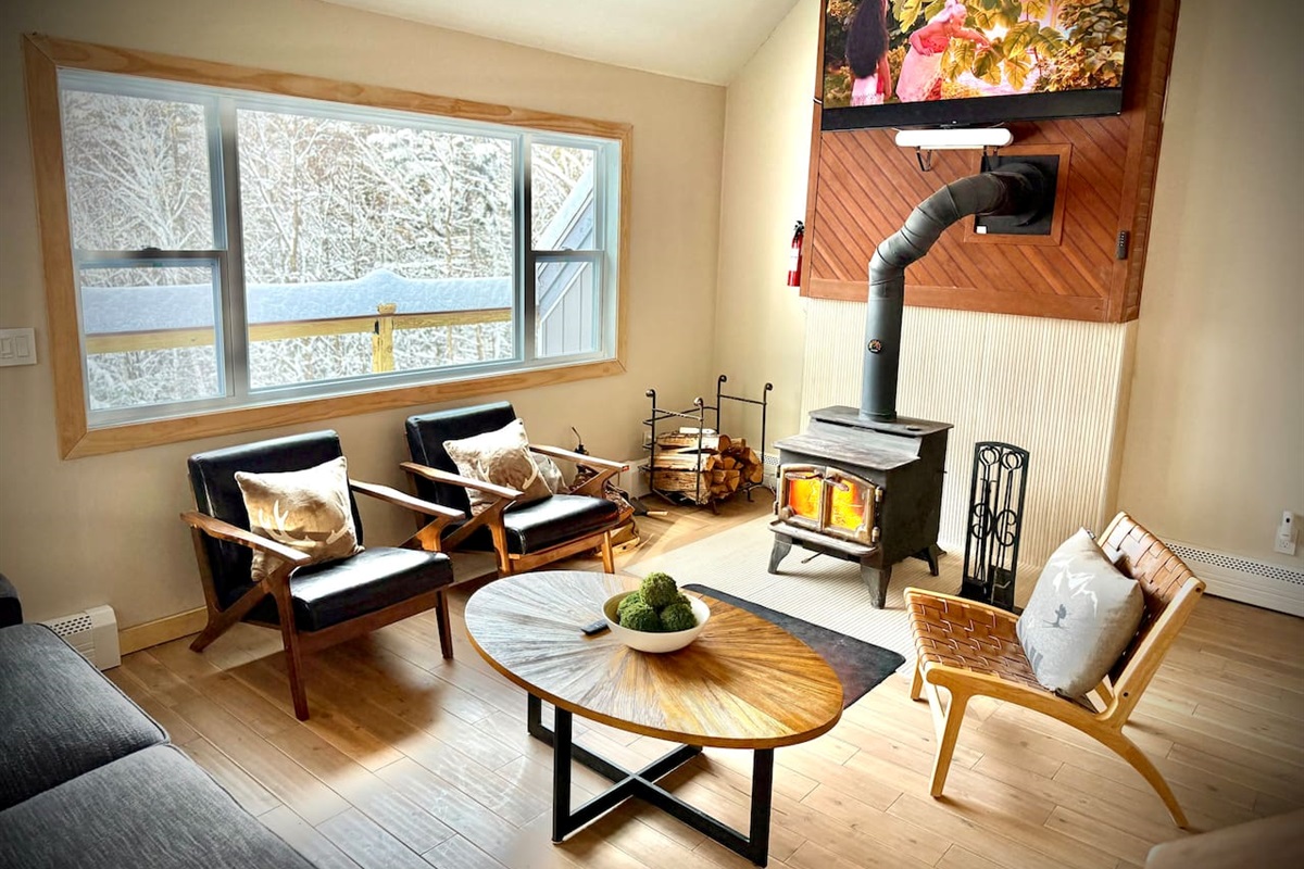 Spacious living room with a cozy woodstove