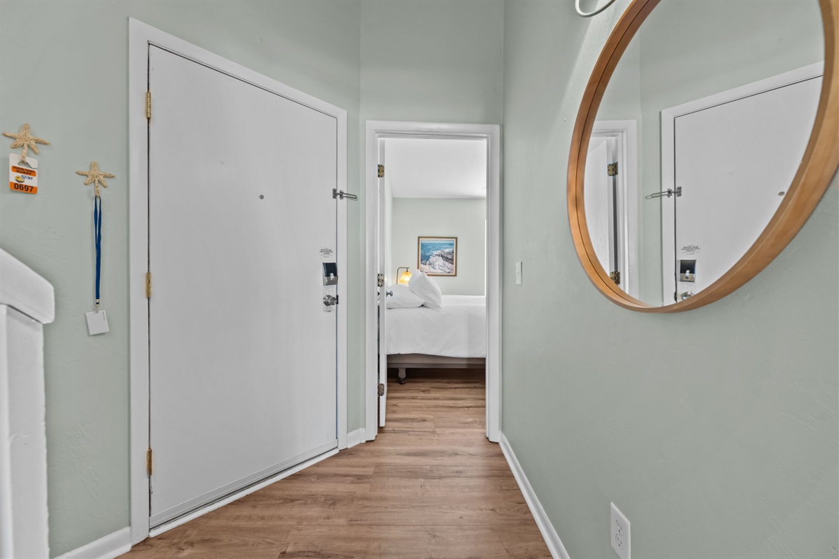 Entry hallway connecting bedrooms and living space with a bright, open feel