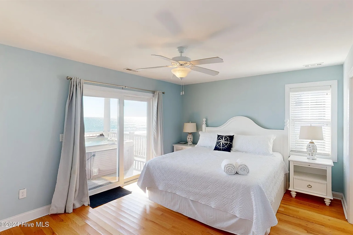 Light-filled bedroom with direct balcony access for morning coffee