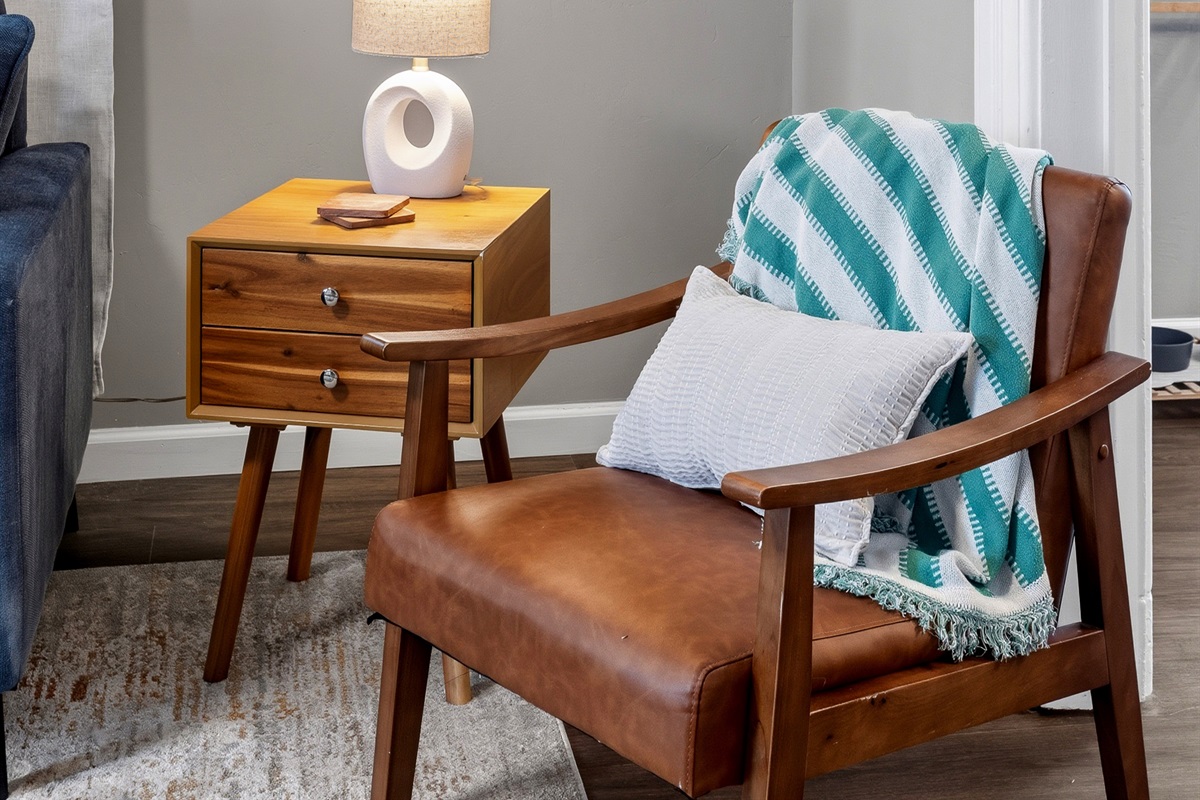 Mid-century accent chair and curated wall art give the space a boutique feel