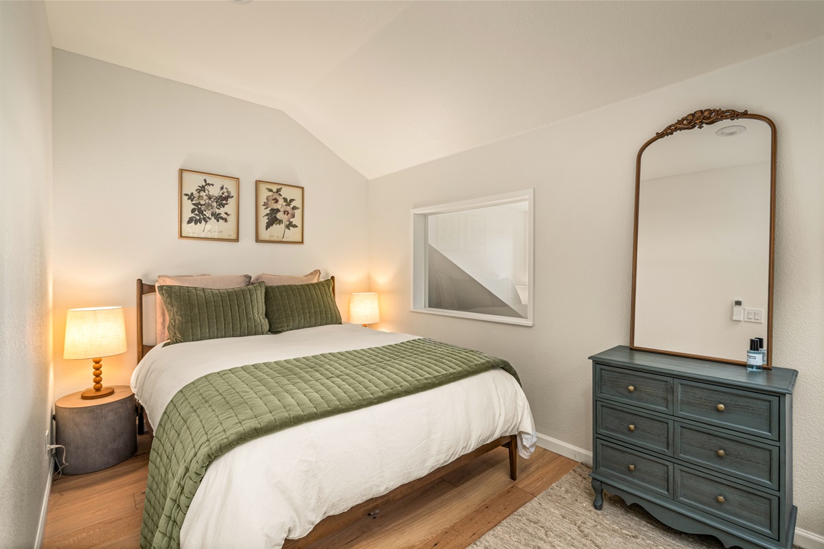 Upstairs second unit feels like a cozy nest with a bird's eye view of the lake through one window and green laurel through the other window. Comfy premium bed and linens with abundant pillows. 