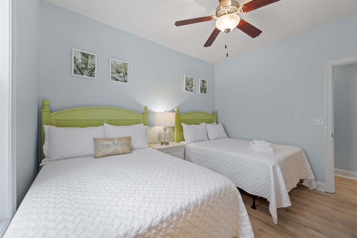 Crisp white linens over both dreamy full-size mattresses in the 2nd bedroom on the first level