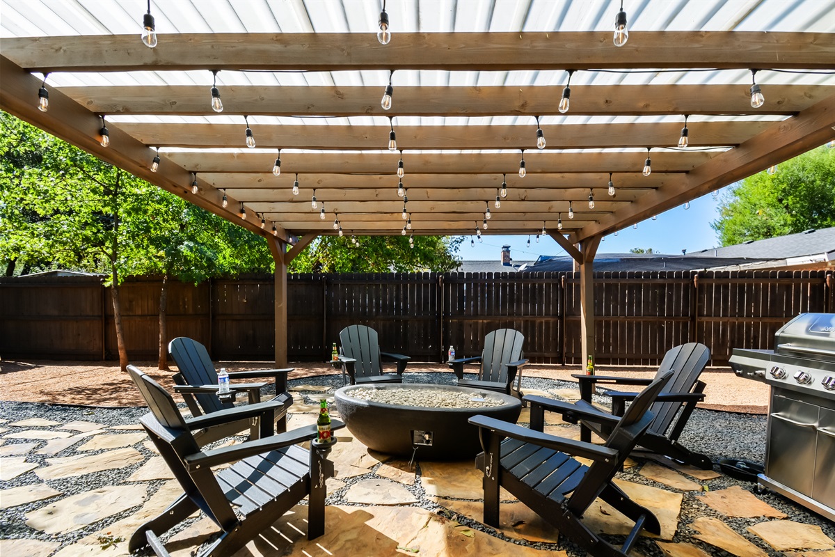 Your Private Fire Pit Oasis → Lighted pergola, 8 Adirondack chairs & twinkling Texas nights — the perfect spot for s’mores, stories & stargazing.