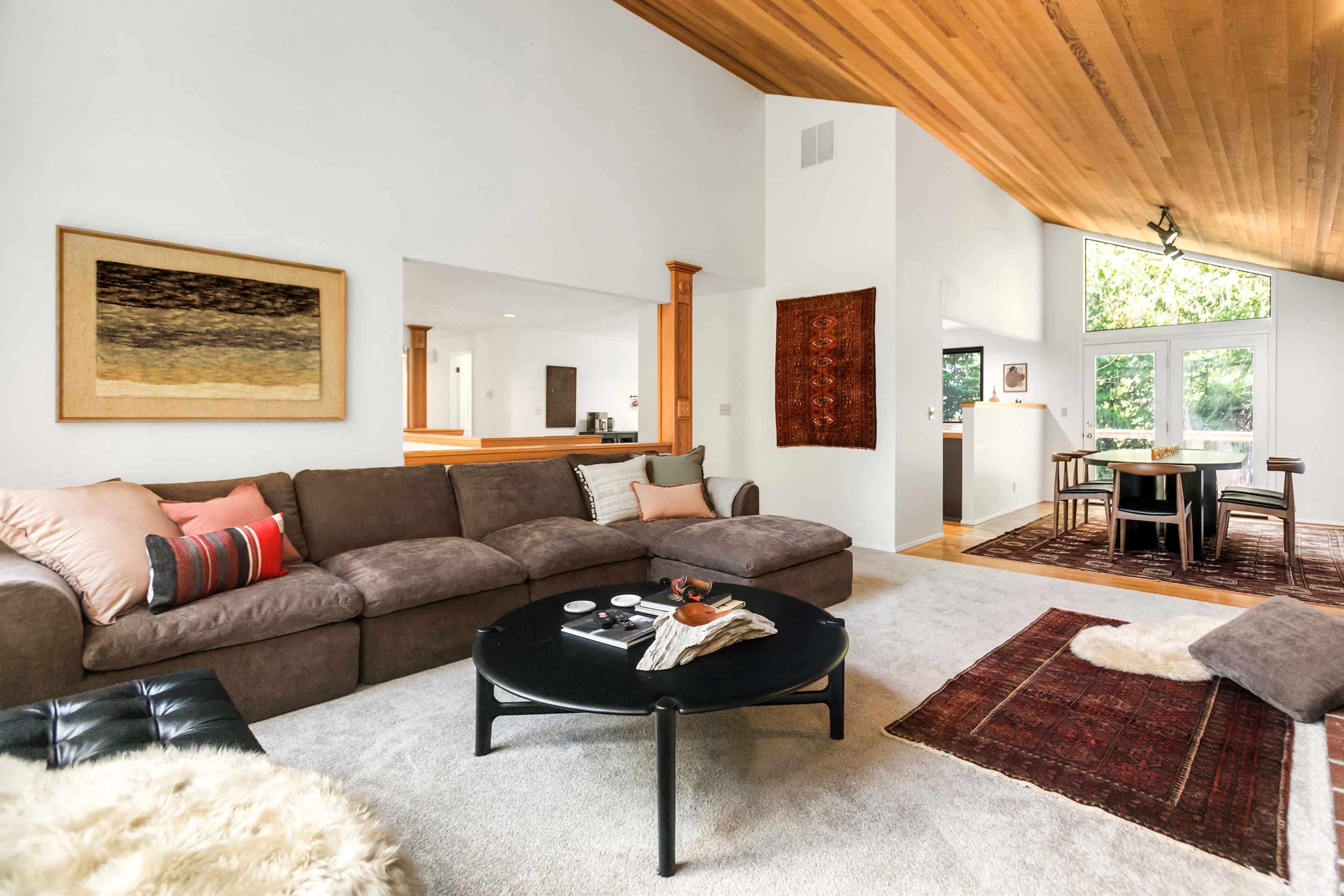 Comfortable sofa, cozy rugs, and designer artwork make this space feel inviting in a way that a hotel never could.