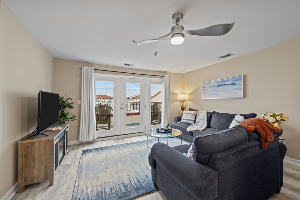Cozy living room with comfy seating and direct access to the balcony for fresh ocean breezes