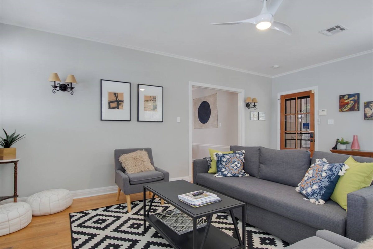 Living room now features a sectional sofa & large screen smart tv.