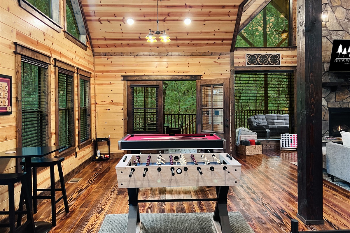 Game area with 6ft pool table, foosball, smart tv and more.